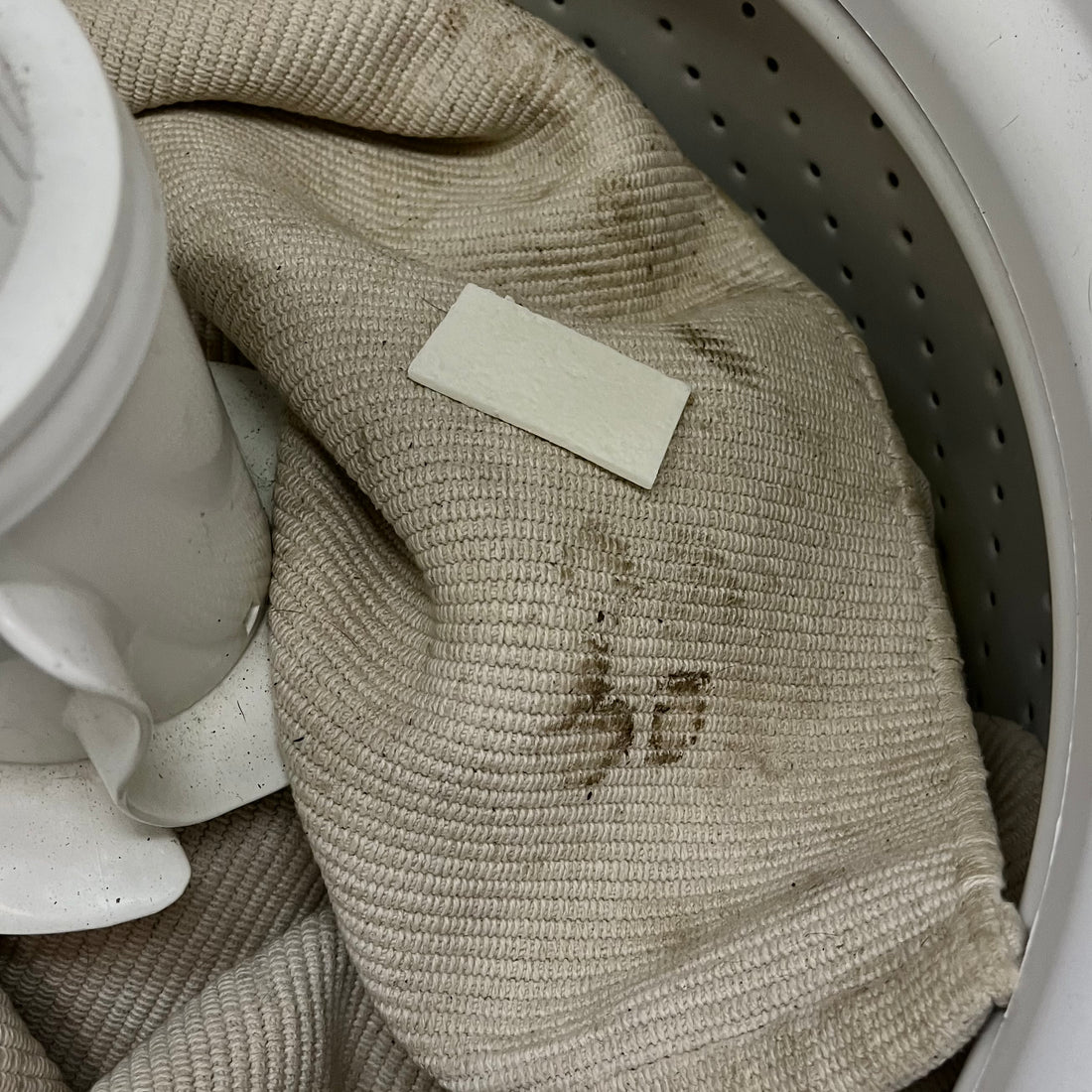 Muddy cream mat before washing