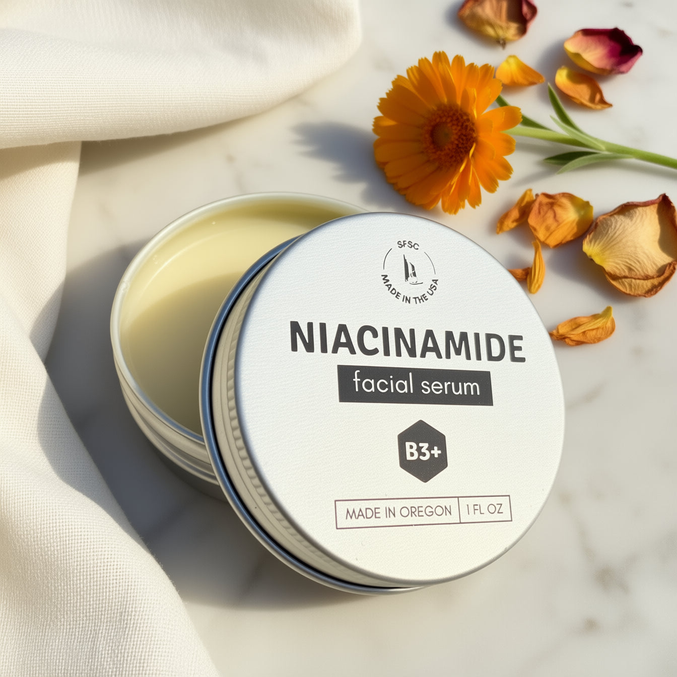 Niacinamide facial serum with flowers on a light background